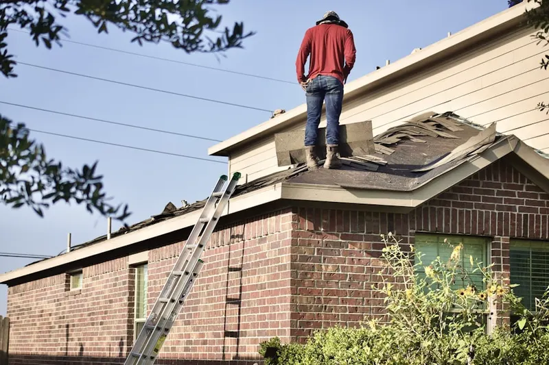 Professional roofer working on a residential roof in Ebensburg Junction